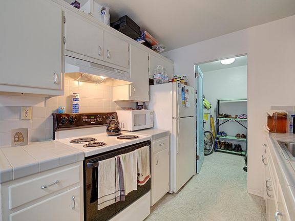 Kitchen with view of office or hobby space in the back ground