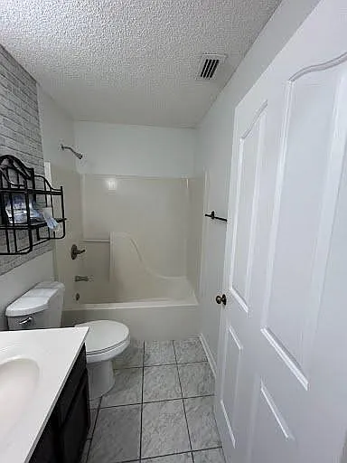 Shared Full bathroom with tub/shower combo, single-sink vanity, and tiled flooring for easy upkeep.