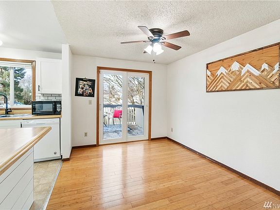 Open kitchen offers seating at the eat bar, beautiful laminate floors, room for a nice big dining table and views of the backyard off the deck.