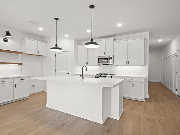 Kitchen with pendant lighting floating shelves