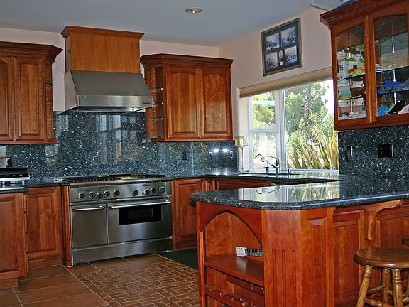 Cherry, granite, stainless all found in pool house kitchen