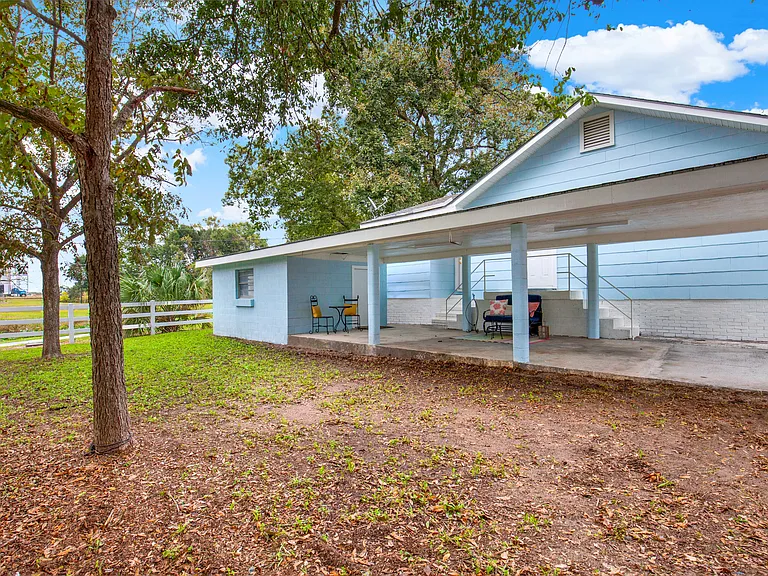 Extra-long covered carport with ample lighting and side entry door
