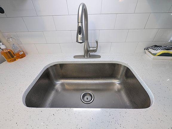 New quartz countertop, sink, and backsplash