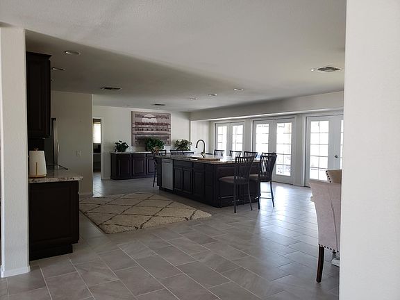 Entrance to kitchen. This is a very large modern open area. Kitchen island is dark cherry with granite countertop.