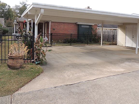 Carport is bid enough for two vehicles and even a golf cart. The storage room has double doors big enough to store a golf cart ,motorcycle or bicycles.