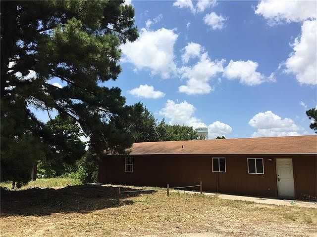 Front of house with large Pine Tree