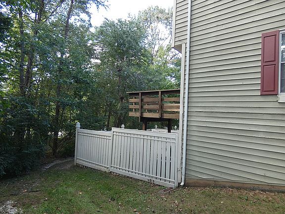 Fenced yard w/woods beyond