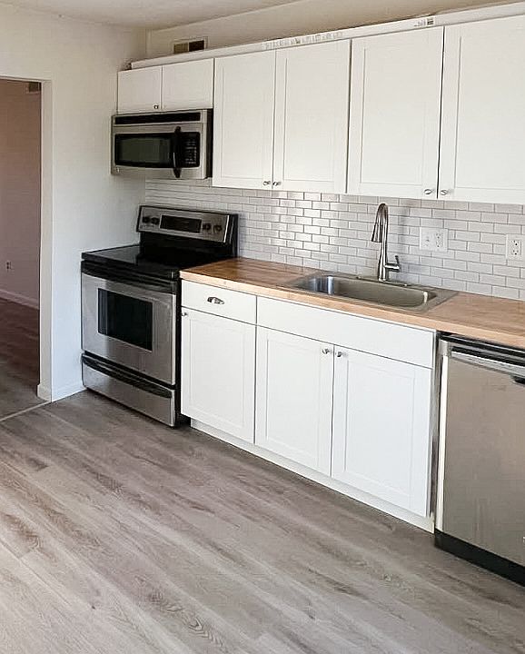 Remodeled kitchen! New subway tile backsplash, real butcher block countertop, stainless steel appliances. Newer LVP flooring in kitchen, hallway, bathroom.