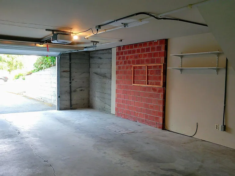Garage with electric door opener.