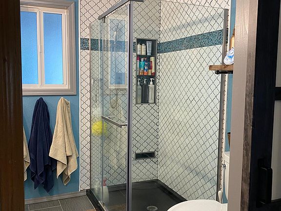 Master bath tile shower with rain showerhead and hand-held as well