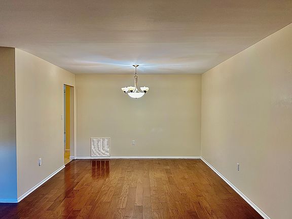 Open concept formal living and dining room, featuring newly installed hardwood floors