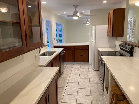 Kitchen has a cubby for a wine refrigerator.
