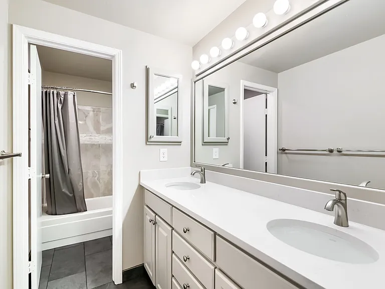 Freshly updated upstairs bathroom with dual sinks and separate shower/toilet room - shared by upstairs bedrooms