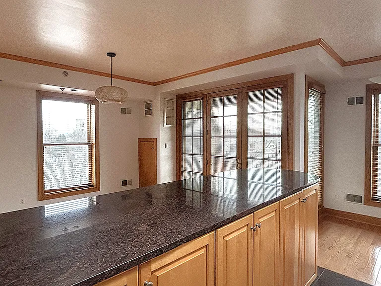 Large granite eat at island. Large French doors leading to attached balcony.