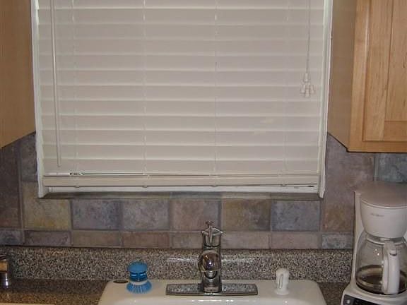 Deluxe chrome faucet, cast iron sink, wide slat window treatments