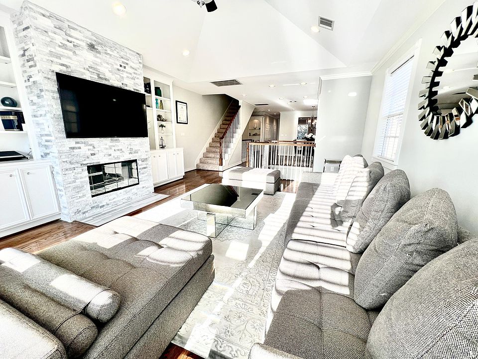 2nd floor- Massive formal living room with stone fireplace. This house gets a lot of natural sunlight! Great open concept for this approx. 3,000sq home.