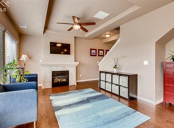 Large living room with an abundance of natural light and gas fireplace.