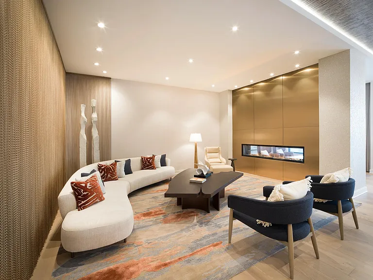 Comfortable seating and a sleek fireplace, offering a welcoming place to relax or connect throughout the day.