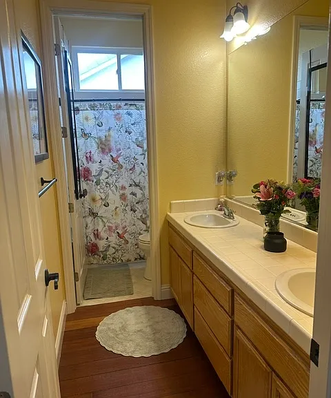 Shared Bath - double sinks, shower over tub. Extra half bath near kitchen, dining, living rooms