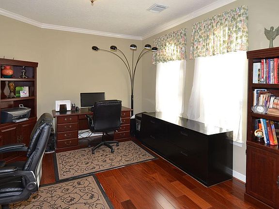 Spacious study with crown molding and recent wood flooring