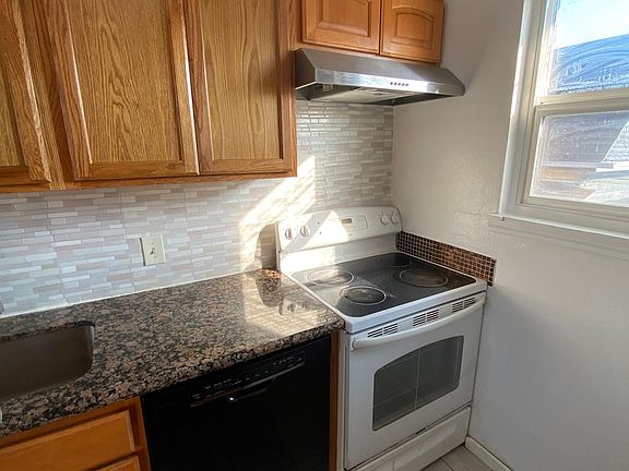 Left side of kitchen; granite countertop , cabinets, dishwasher, hood and stove installed about 2 years ago