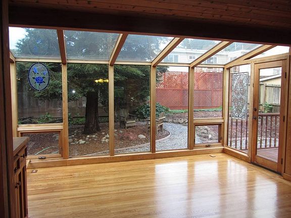 Spacious Lindal Cedar Sunroom overlooks the enclosed backyard. Great bonus room.