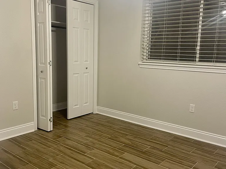 Spacious guest bedroom (2/4) featuring a closet and easy access to the hall bathroom.