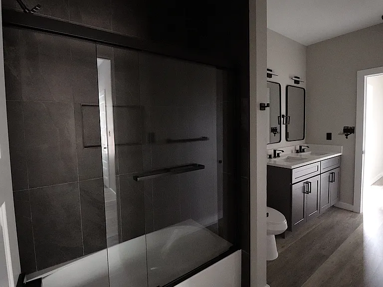 Bright and stylish secondary bathroom with dual sinks, contemporary finishes, and generous counter space.