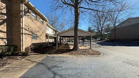 Front entrance and carports assigned to each unit with lots of parking spaces.