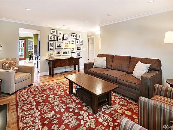 Another angle of the living room showing the entrance to the kitchen (on the upper left of this photo) The front door is off to the right and gives access to the hallway to bedrooms, bathrooms, and laundry room.