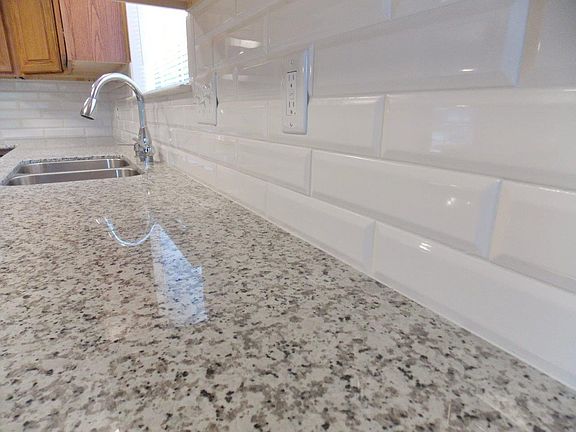 Beautiful granite counters and beveled tile backsplash.