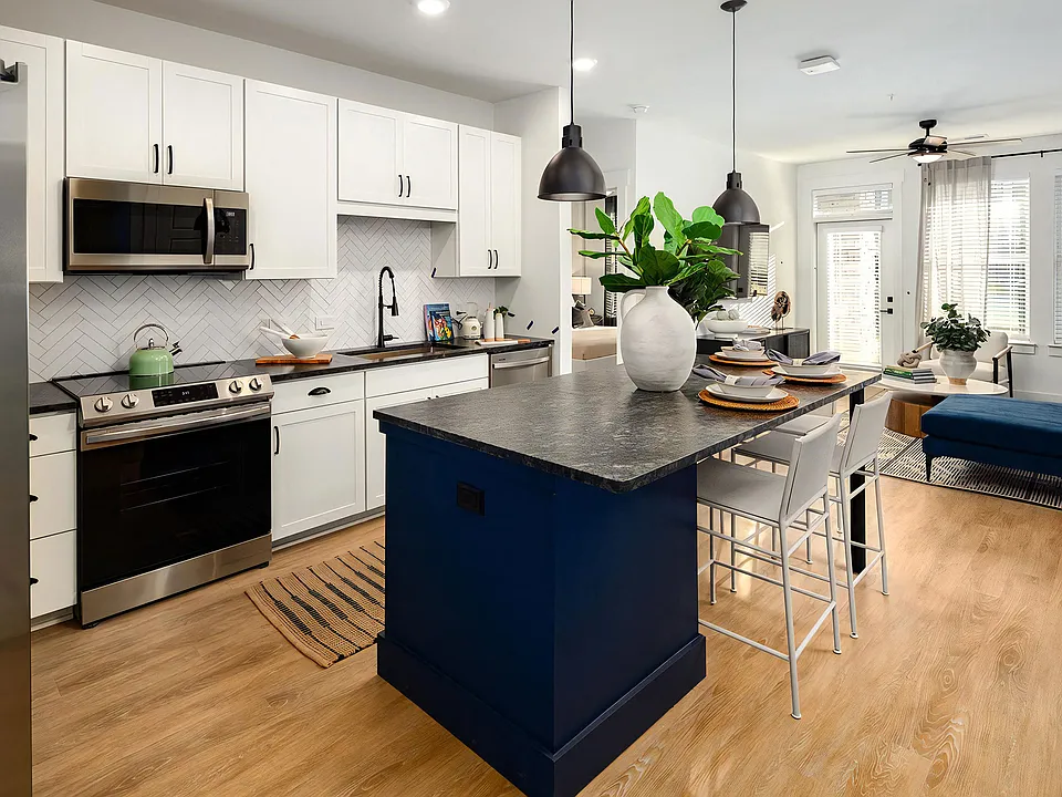 Open-Concept Kitchen with Pendant Lighting and Stainless Steel Appliances
