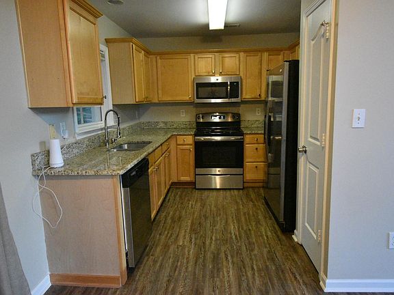 Kitchen features granite countertops, stainless steel appliances, built-in microwave, and a pantry!
