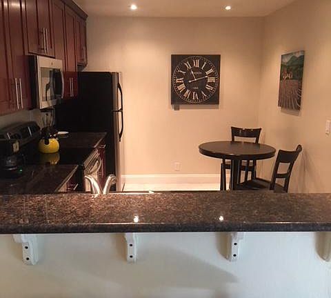 Kitchen includes stainless steel appliances and a breakfast 