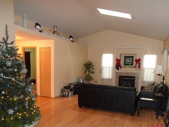 Great Room or LR with gas fireplace slider to cov patio & skylight