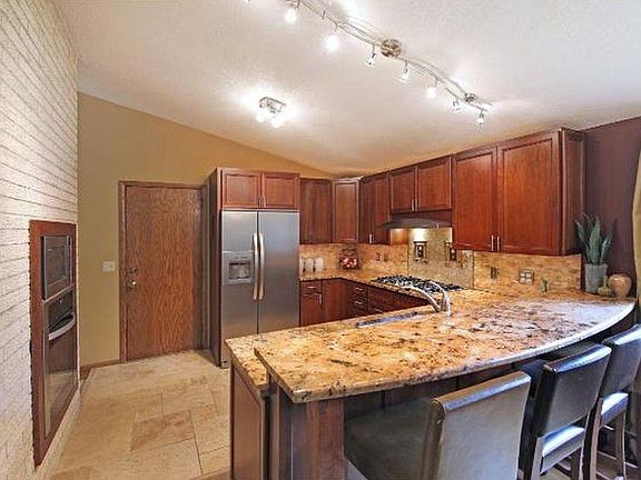 Kitchen with 3-seat island and separate dining area