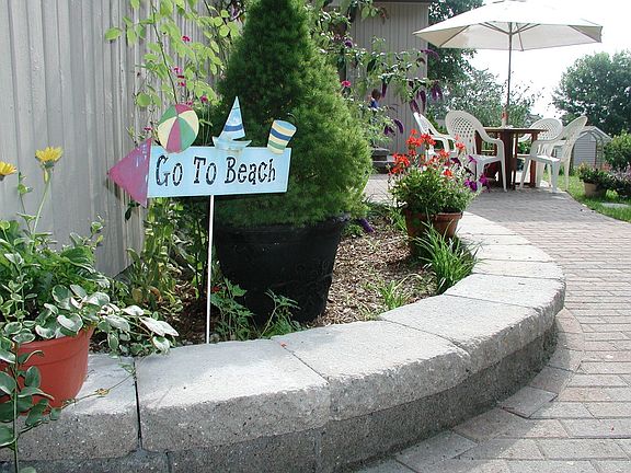 New paver walkway runs from driveway to main entry at south side of home...