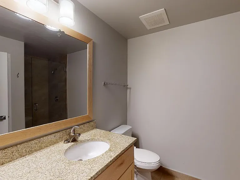 Apartment bathroom with tile flooring.
