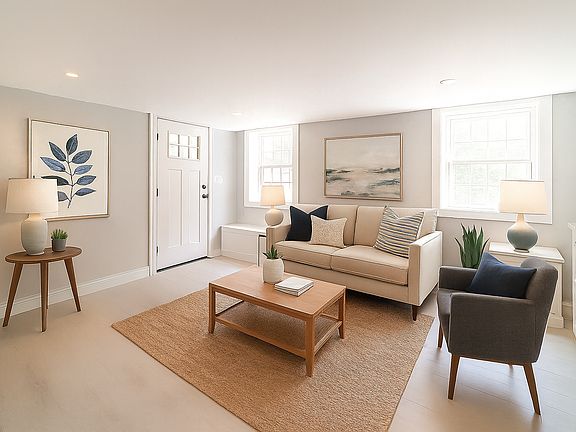 Staged photo of entry/living area. Apartment is unfurnished.