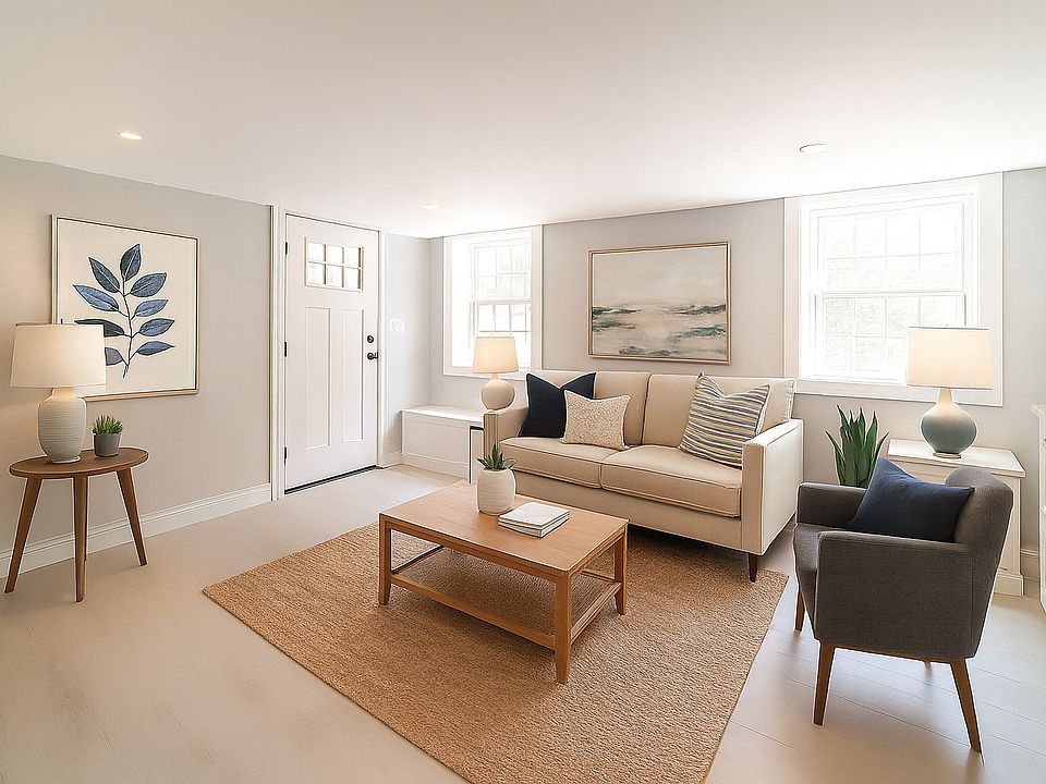 Staged photo of entry/living area. Apartment is unfurnished.