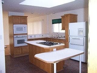 Kitchen view from hallway. Note: Appliances have been replaced with stainless steel since this photo was taken.