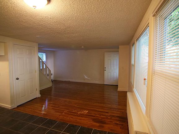 View from kitchen area back towards the living room. Stairs to 2nd floor towards the back left.