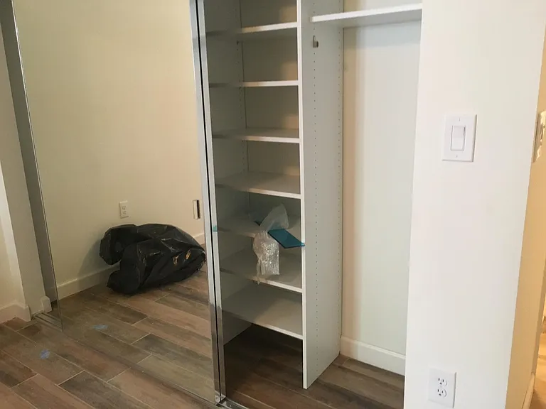 main bedroom closet with full shelving.