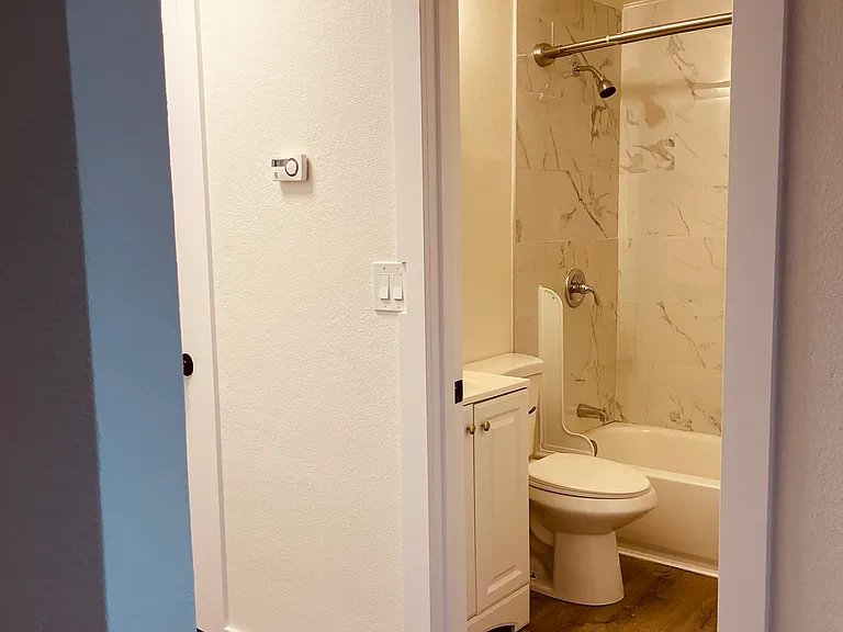 Hallway with bathroom in between two large sized bedrooms. Storage closet to store extra items.