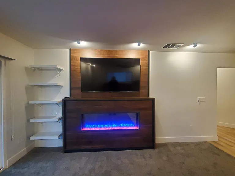 Electric fireplace with changing colored lights and provides heat too. Remote control included. We also provide central heat and air conditioning in the home.