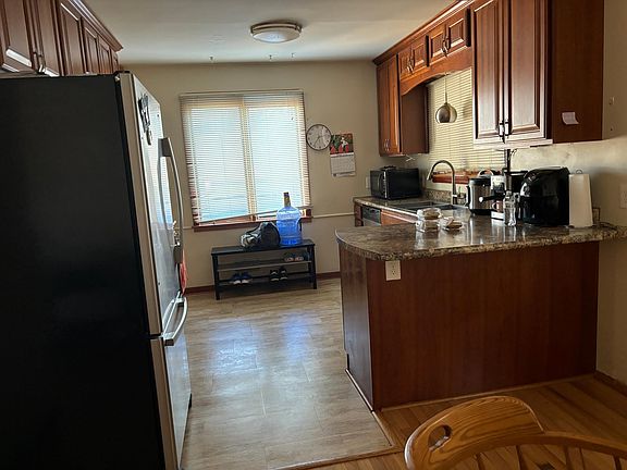 Open kitchen to eat-in area. Gas stove, dishwasher, new fridge!