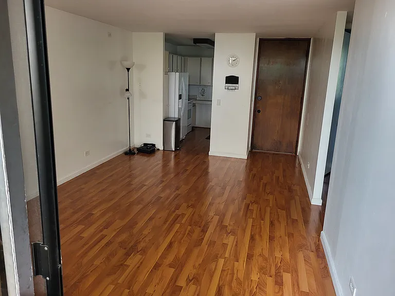 Living/dining room facing kitchen and entry door