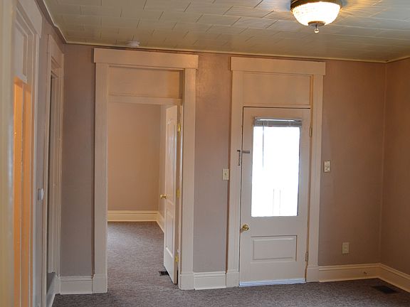 Living Room looking towards Front Door and Downstairs Bedroo