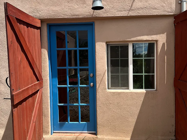 Separate studio has entrances from the fenced-in back yard as well as from the driveway.