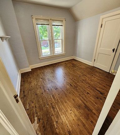 Dining room with hardwood floor overlooking south walk out to roof.